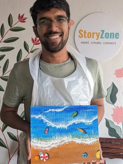 A participant with his stunning texture painting of a beach scene. The texture paste creates realistic waves and sand, making the artwork come alive.