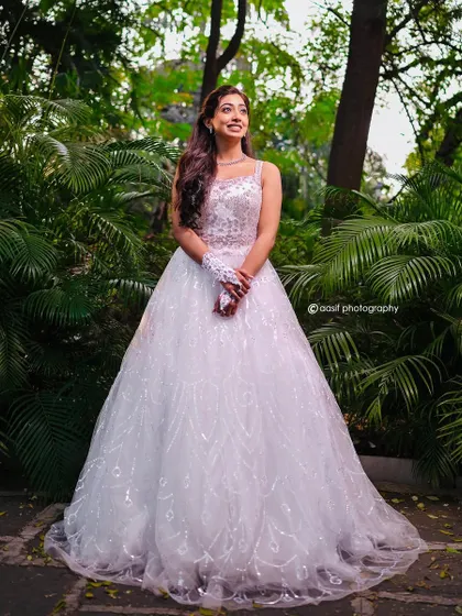 A beautiful smile to match a beautiful gown. This white ball gown with its subtle sparkle is perfect for creating a radiant and angelic look for your wedding day.