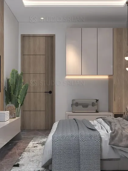 A full view of a bedroom in Shiv Vihar, showcasing a mix of wood textures on the TV wall and door, paired with clean, white furniture.