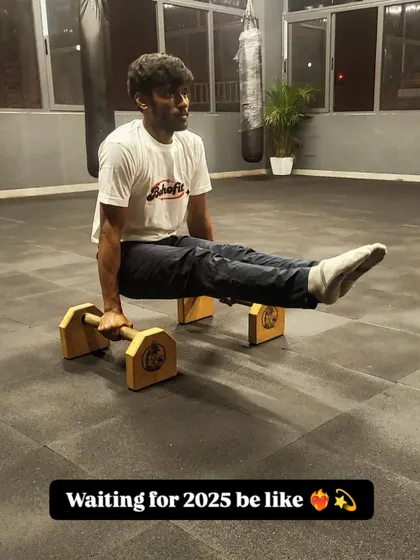 Just holding an L-sit on the parallettes, waiting for 2025. It's all about building that core strength and patience, one hold at a time.