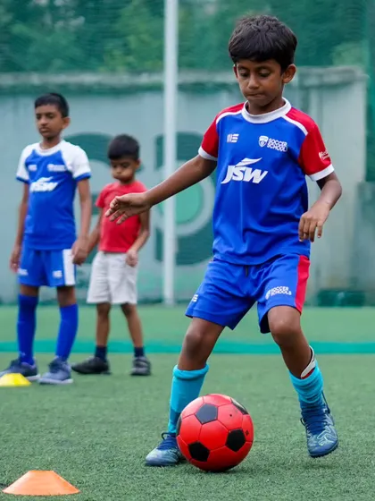 A player dribbles through a cone drill, demonstrating focus and control. These exercises are essential for building a strong technical base.