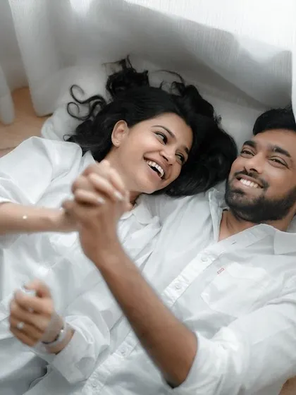 A quiet, candid moment shared between a couple during their indoor pre-wedding session. The focus here is on their natural interaction and the comfortable silence they share.