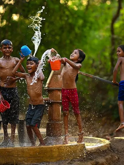 The pure energy of a village summer, frozen in time. This shot from my "Childhood Summers" series captures the simple, uninhibited happiness of kids playing near a handpump in rural Maharashtra.