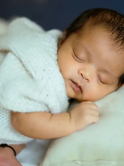 A tight shot on the sleeping baby's face. These are the moments you'll want to remember forever, and I focus on capturing that pure innocence.