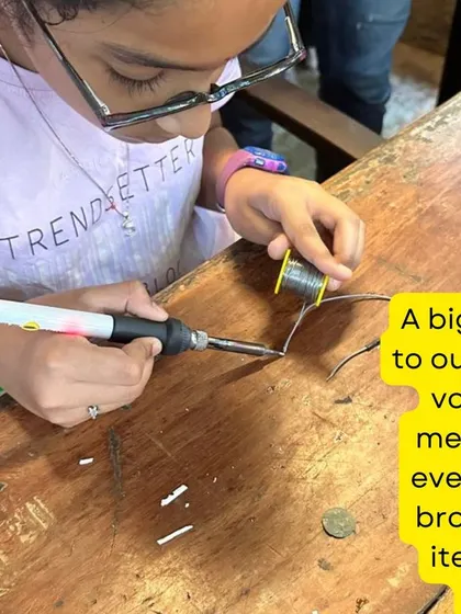 Learning to solder is a key skill for many electronic repairs. Here, a young participant gets careful instruction from a mentor, building confidence and technical ability at our Hyderabad workshop.