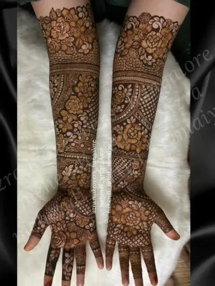 A beautiful and intricate full arm bridal design, showcasing a mix of floral and geometric patterns.