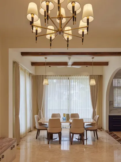 The dining room of our 'Seychelles' project, which brings Mediterranean elegance to Bangalore. The design features arched frames, marble finishes, and warm wooden tones for a look of rare luxury and warmth.