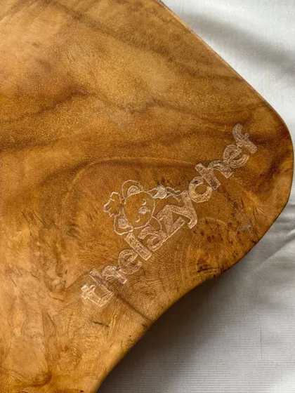 My engraving isn't just for glass and metal. I love the challenge of working with different textures, like this beautiful wooden cheeseboard. I personalized it with a custom logo for 'thelazychef', and I'm obsessed with how the natural grain of the wood makes the design pop.