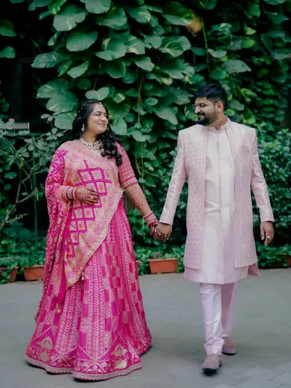 The newly engaged couple walks hand in hand, sharing a look of love and excitement for their future together.