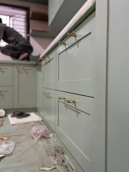 This kitchen is a statement piece. We handled the complete installation, from the pastel-shaded shaker cabinets to the classic brass hardware, ensuring every detail was perfect.