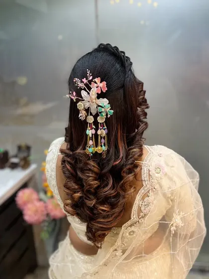 Another angle of the statement floral accessory, showing how it drapes down the hair. This is a great example of how to create a unique focal point in a hairstyle.