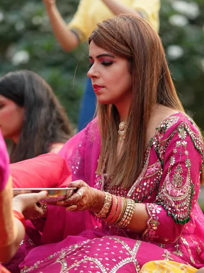 Another moment from the Karwa Chauth celebration, showing the detailed henna art on the hands.