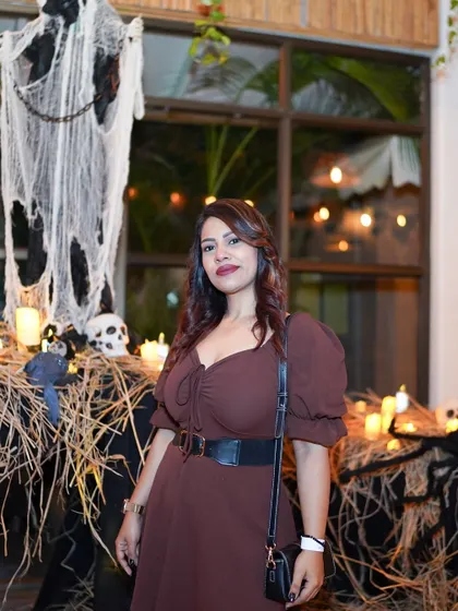 A guest posing by the spooky decorations. We transform the entire venue to fit the theme.