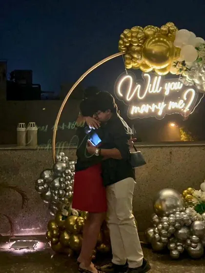 The hug that says it all. A beautiful, candid moment right after the 'yes', with our "Will you marry me?" neon sign glowing in the background. We are so grateful to witness these memories.
