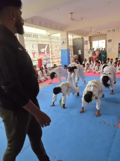 I observe the class as they perform their warm-up exercises.