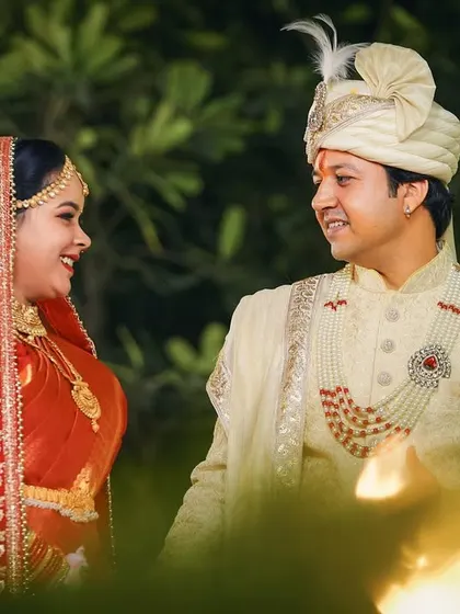 A beautiful candid portrait of the couple sharing a happy glance. The soft, warm lighting in the foreground adds a dreamy, romantic feel to the photo.