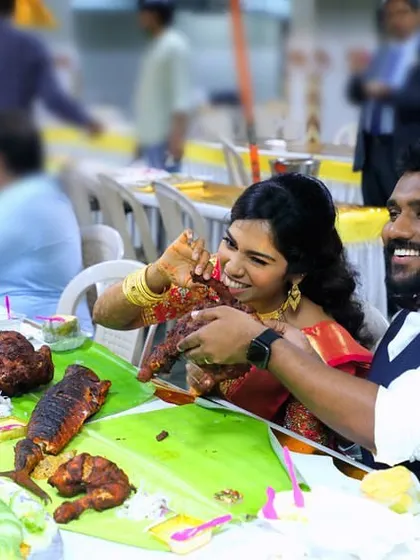The joy of sharing a meal. A bride and groom enjoying their lavish spread at the BKN Auditorium in Egmore.