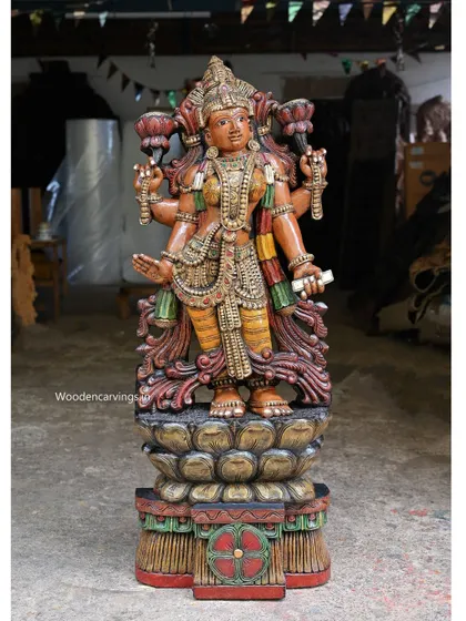 A 47-inch statue of Goddess Lakshmi standing on a double petal lotus. This large, colorful statue is a cheerful and auspicious presence, perfect for a prominent place in a home or business.