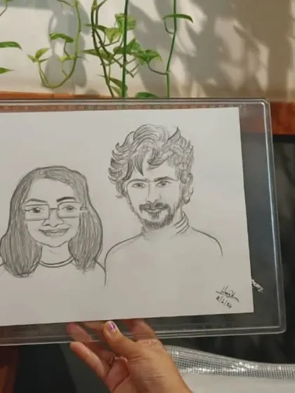 A duplicate image showing the detail of a hand-drawn couple's caricature.