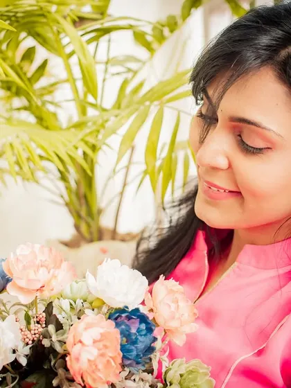 A soft and gentle portrait with flowers. The natural elements and serene expression create a beautiful and peaceful image.