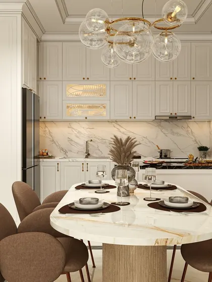 This dining area is integrated with an open kitchen, showcasing a beautiful marble-top table and plush brown chairs. The bubble chandelier adds a modern, artistic touch, while the white cabinetry keeps the space feeling bright and airy.