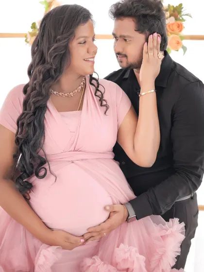 A close-up shot capturing the loving expressions between a couple during their maternity session. The soft lighting enhances the romantic mood.