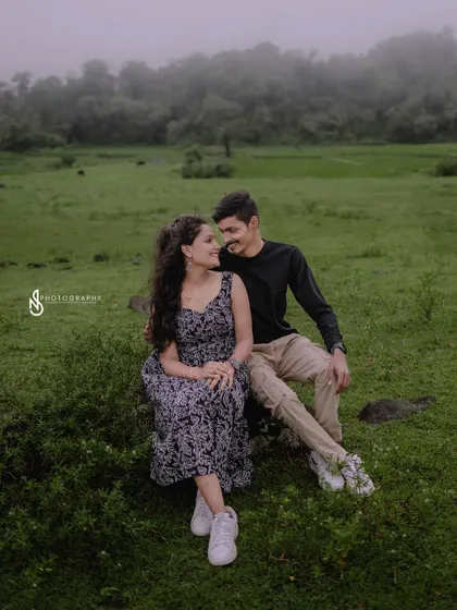 A quiet moment together, sitting on a rock in a misty green field. This is a perfect example of a peaceful, romantic portrait.