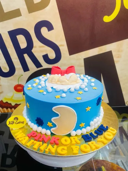 A 1.5kg "Pink or Blue, Waiting for You" baby shower cake with a sleeping baby topper.