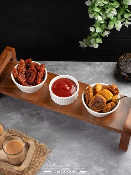 This shot is for a wooden serving tray. I styled it with Indian snacks and chai to show the product in a realistic use-case scenario, helping customers imagine it in their own homes.
