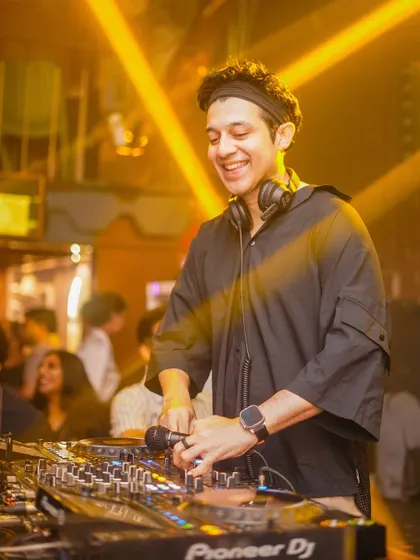 A close-up of me at the Pioneer DJ decks, focused on the mix.