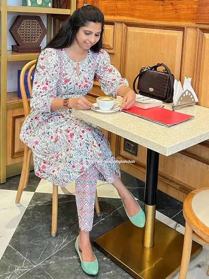 Enjoying a coffee in our bestselling printed set. This outfit is versatile enough for a casual cafe visit or a more formal event.