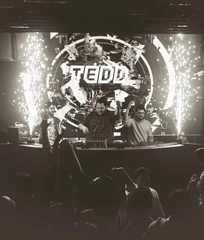 A classic black and white shot with pyro erupting, creating a timeless and epic party moment.