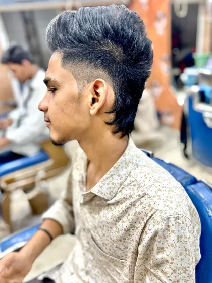 A clear profile of the subtly faded mullet. The focus here is on the shape and flow of the hair, creating a stylish and relaxed look.