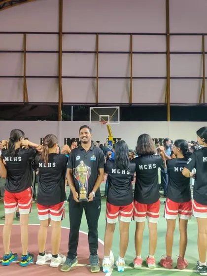 A powerful image of our coach with the U16 girls team, celebrating their collective achievement at the state level.