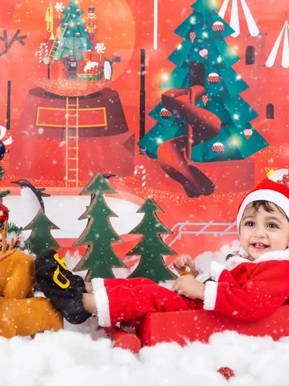 A fun, candid shot of a baby Santa enjoying his sleigh ride in our festive Christmas setup.