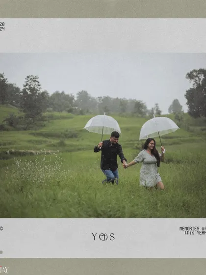 A vintage-style photo of a couple running through a green field in the rain with umbrellas.