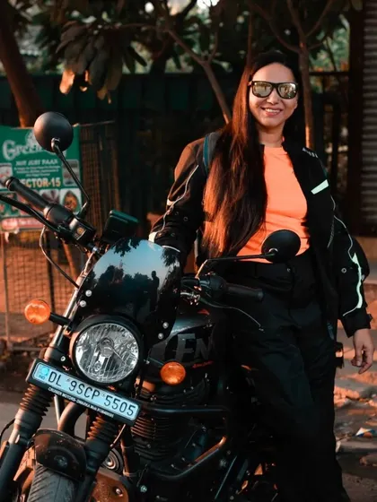 A portrait of a female rider with her Royal Enfield Hunter. It's important to showcase the diversity of the riding community, and this shot captures her confidence and style.