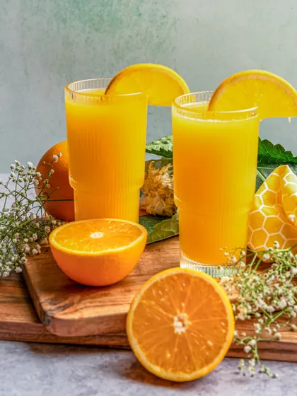 A bright and refreshing shot of freshly squeezed orange juice for Earth Café. We use natural lighting and simple styling with fresh fruit to emphasize the natural quality of the beverage.