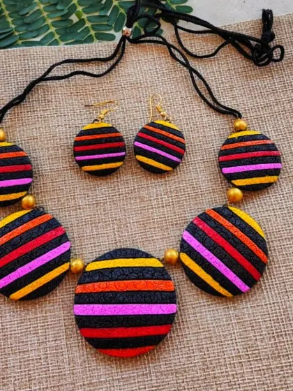 A warmer version of the striped circle necklace, featuring pink, orange, and yellow stripes.
