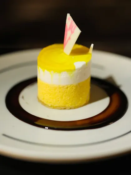 Another view of the elegant Mango and White Chocolate Mousse, showcasing its clean layers and delicate white chocolate garnish. It's a light, refreshing, and sophisticated dessert.