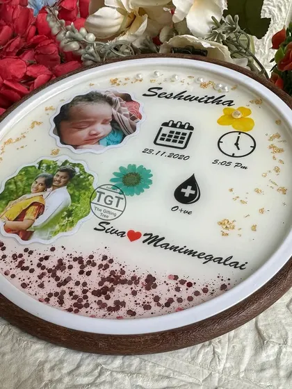 This 8-inch round frame is set in mango wood, giving it a warm, natural look. It includes the baby's name, birth details, blood type, and photos.