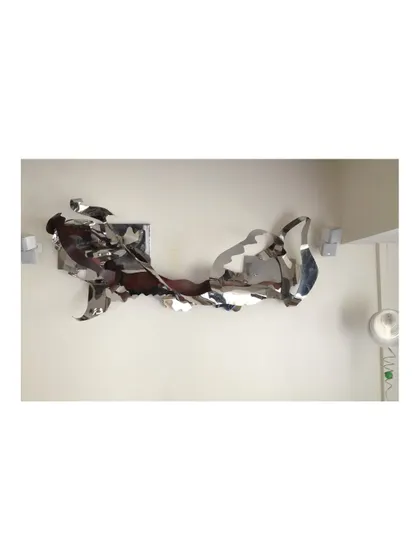 The full length of the 12-foot wall sculpture, which creates a powerful sense of horizontal movement.