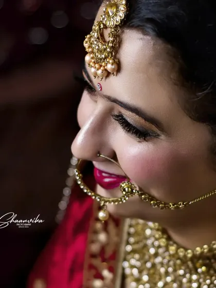 A side-profile close-up, highlighting the bride's elegant nose ring (nath) and her beautiful smile.