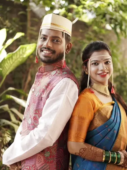 A bright and happy back-to-back portrait in a lush, green setting.