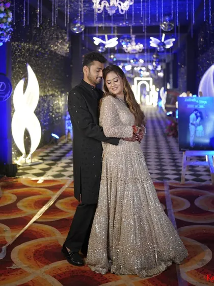 A full-length shot of the couple, showing the bride's gorgeous flowing lehenga, perfect for a night of dancing.