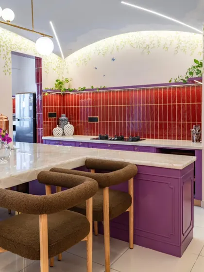 The kitchen in Project Sakura is a bold expression of personality. I used deep red tiles and rich purple cabinetry, softened by hand-painted vines and butterflies that trail across the ceiling and walls. This space proves a kitchen can be both functional and a masterpiece of self-expression.