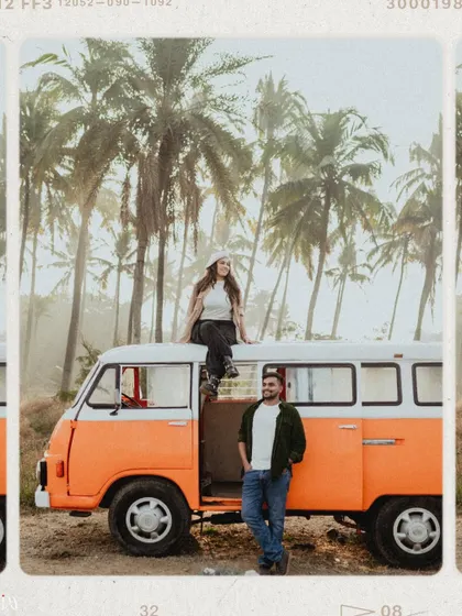 A cool, editorial-style shot of the couple with the vintage van, set against a backdrop of palm trees.