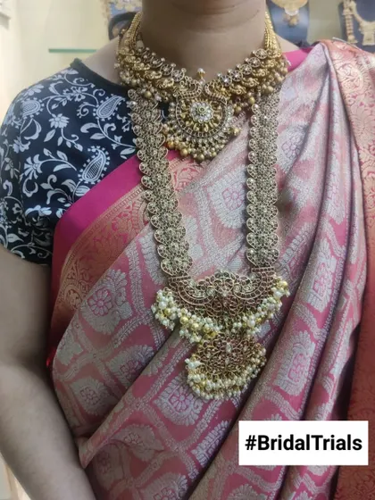 A client trying on a grand, pearl-studded gutta pusalu haram during her bridal trial. It's a great way to see how statement pieces feel and look.