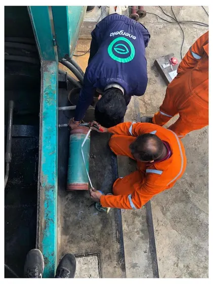 An overhead view of our engineers taking precise measurements on a piece of machinery. Attention to detail is critical in our process to ensure our solutions are perfectly tailored to each facility's unique systems.