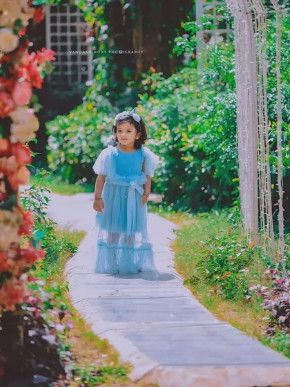 A real-life Cinderella story captured in a beautiful garden. The dreamy lighting and her elegant blue dress make this a truly magical photo.